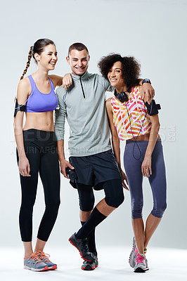 Buy stock photo Shot of three young adults wearing sports clothing in a studio