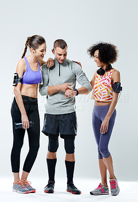 Buy stock photo A young man showing his two female friends his wristwatch