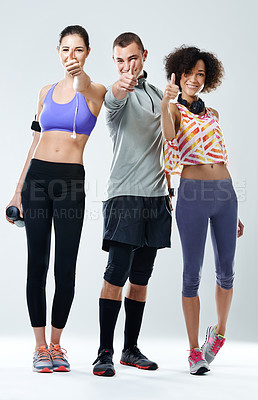 Buy stock photo Three friends showing thumbs up while wearing sports clothing