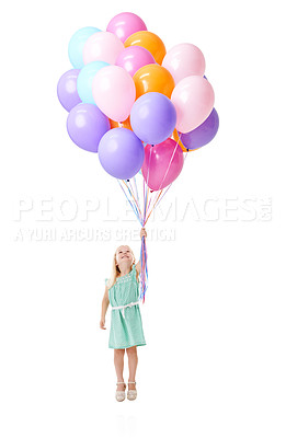 Buy stock photo Little girl, flying and floating with colorful balloons in air for helium, birthday or event in studio on a white background. Young female person, child or kid with smile for blow up, flight or rise