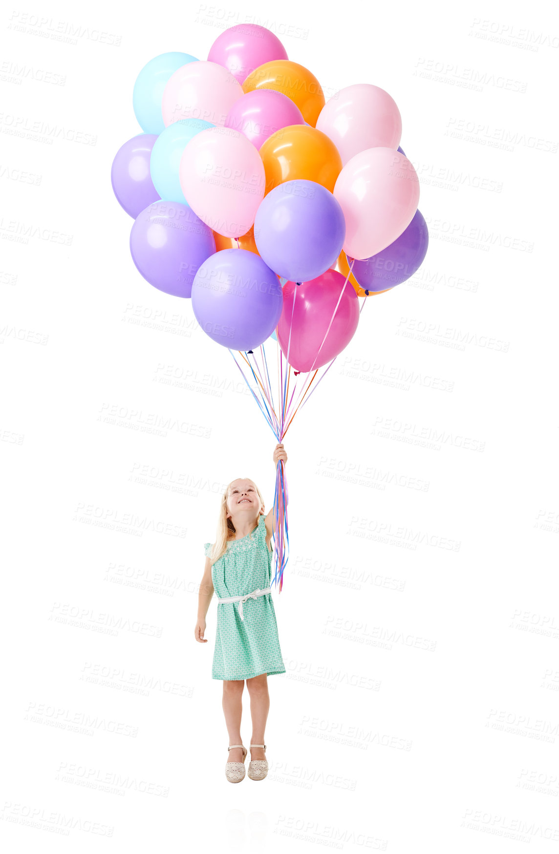 Buy stock photo Little girl, flying and floating with colorful balloons in air for helium, birthday or event in studio on a white background. Young female person, child or kid with smile for blow up, flight or rise