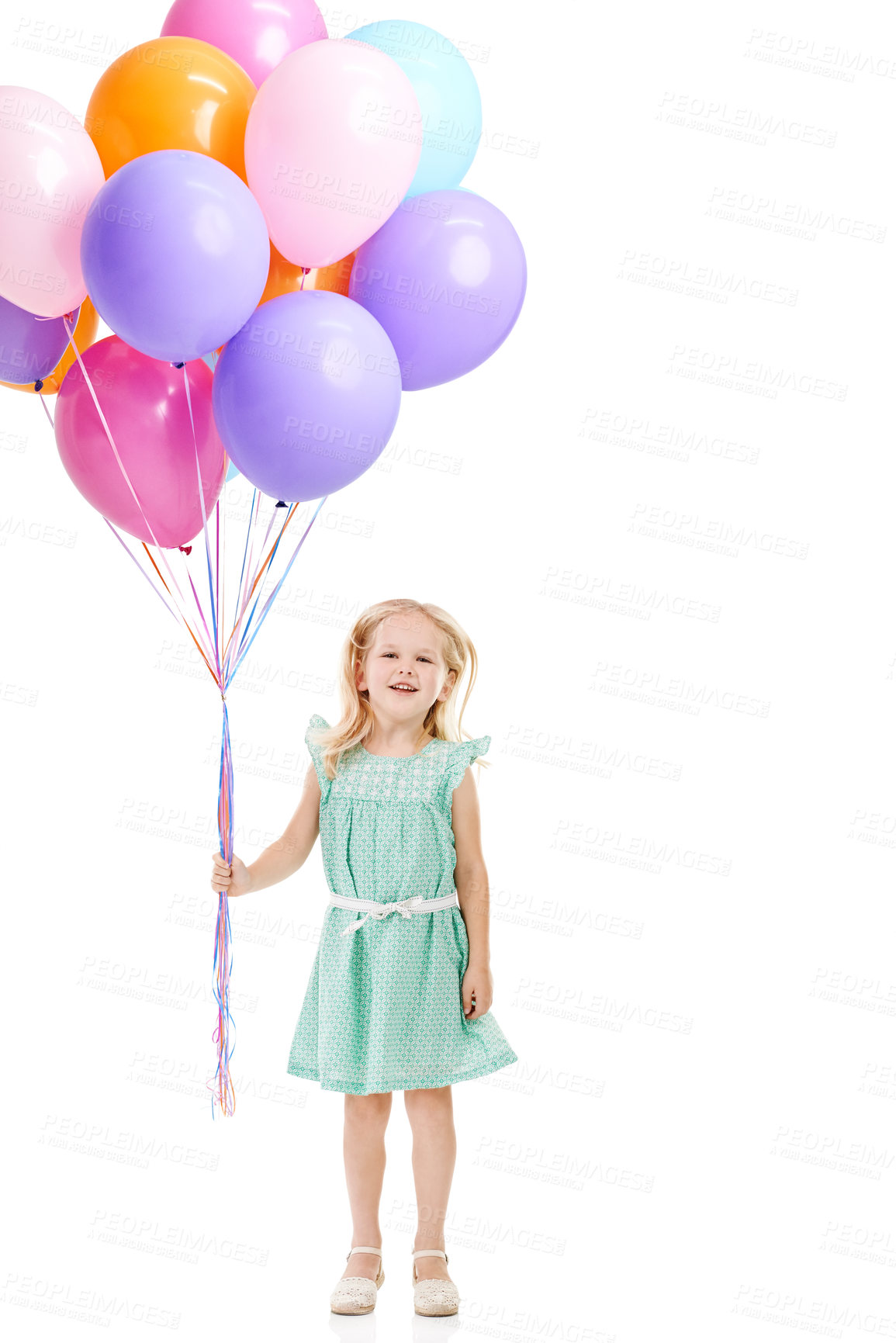 Buy stock photo Studio shot of a cute little girl holding a bunch of balloons against a white background 