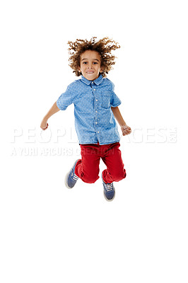 Buy stock photo Studio shot of a cute little boy jumping for joy against a white background