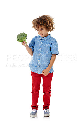 Buy stock photo Boy, child and bored with broccoli in studio for choice, disgust and confused with food by white background. Kid, vegetable and thinking for decision with meal, nutrition and annoyed by mockup space