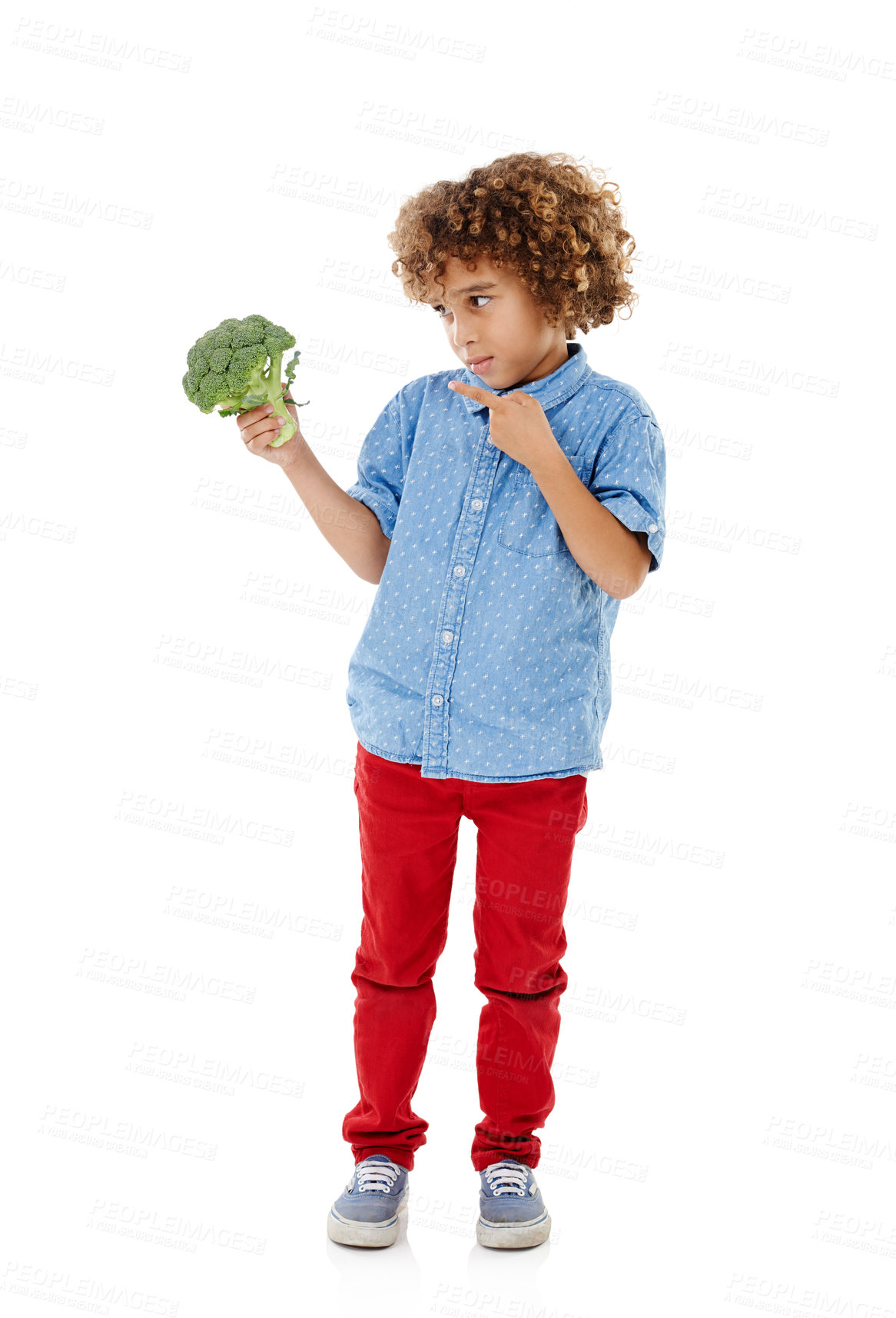 Buy stock photo Young boy, pointing and broccoli with vegetable for nutrition, healthy snack or vitamins in studio on a white background. Male person, child or kid with natural organic food for fiber or vegetarian