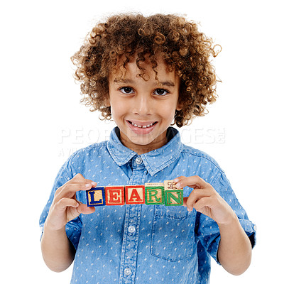 Buy stock photo Word, building blocks and portrait of kid in studio for learning, education or child development. Creative, childhood and isolated young boy with school toys for spelling games on white background