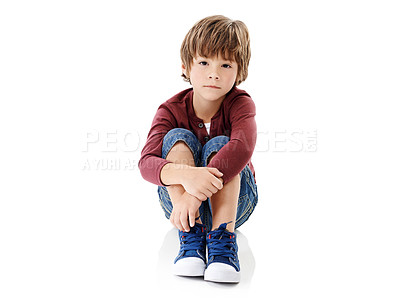 Buy stock photo Studio shot of a cute little boy hugging his knees against a white background