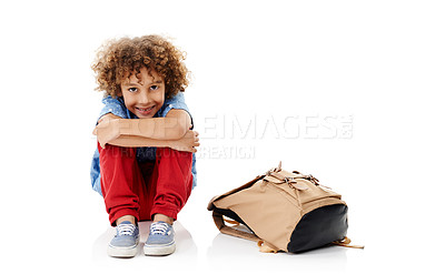 Buy stock photo Child, boy and portrait with backpack in studio for back to school, mockup space and happy for education on floor. Student, kid and smile with schoolbag for learning and studying on white background