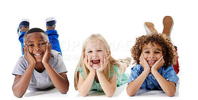 Buy stock photo Studio shot of a group of young friends lying on the floor together against a white background