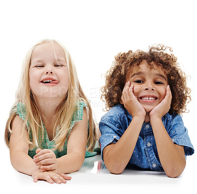 Buy stock photo Studio shot of two young friends lying on the floor together against a white background