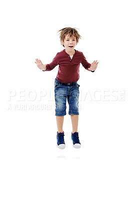 Buy stock photo Studio shot of a cute little boy jumping for joy against a white background