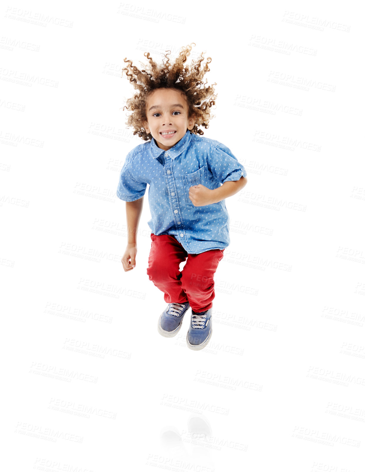 Buy stock photo Studio shot of a cute little boy jumping for joy against a white background