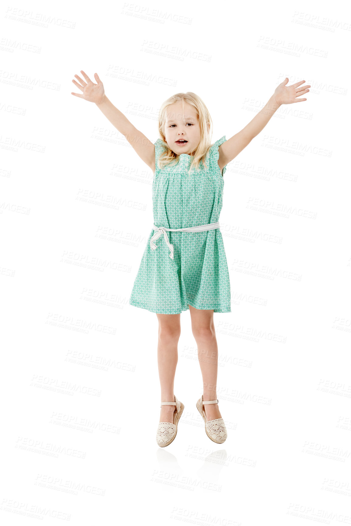 Buy stock photo Studio, smile and girl in portrait for jump, hands up and fashion dress for first day of kindergarten. Space, child and development with flying game for playing, energetic and white background