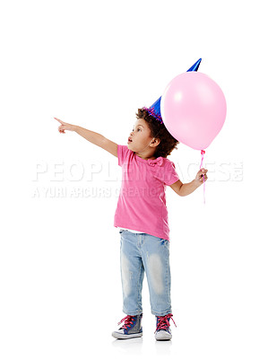 Buy stock photo Balloon, party hat and child in studio pointing for birthday, celebration or fun with event. Smile, decoration and kid with flying inflatable helium accessory for gift isolated by white background.