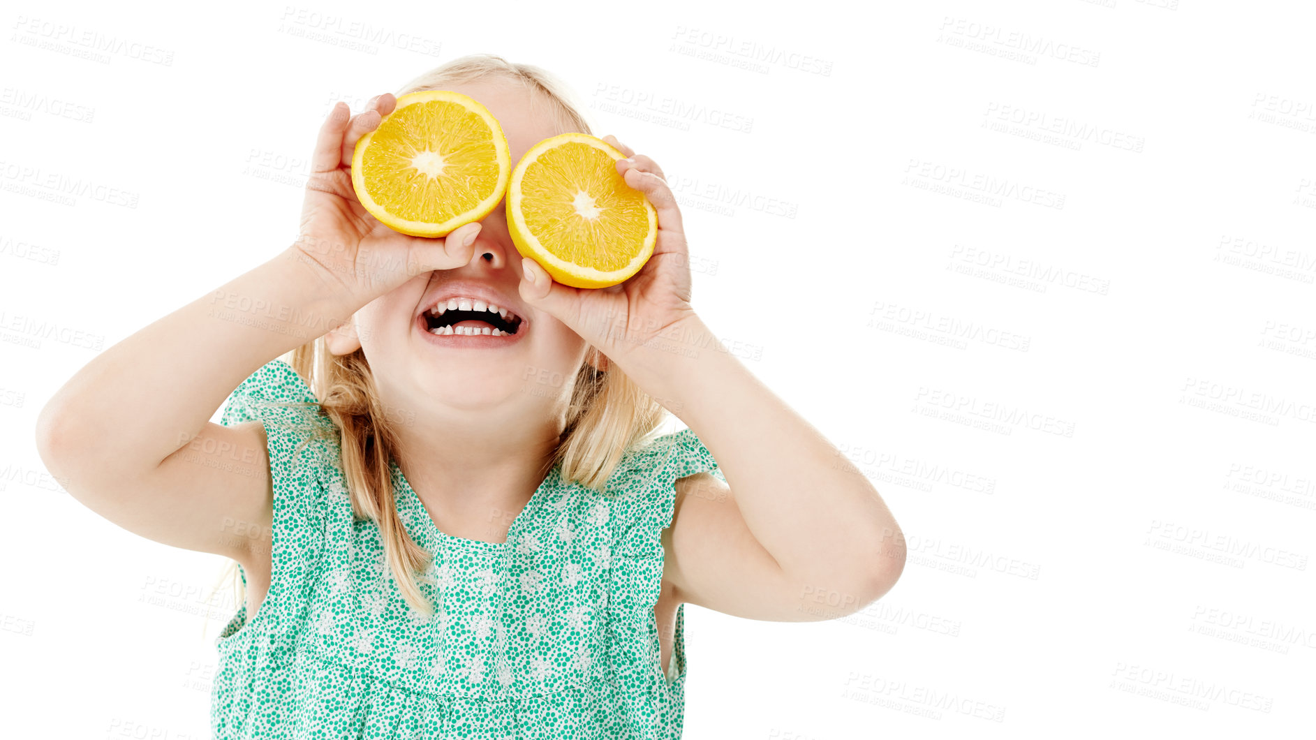 Buy stock photo Studio shot of a cute little girl playfully covering her eyes with oranges against a white background