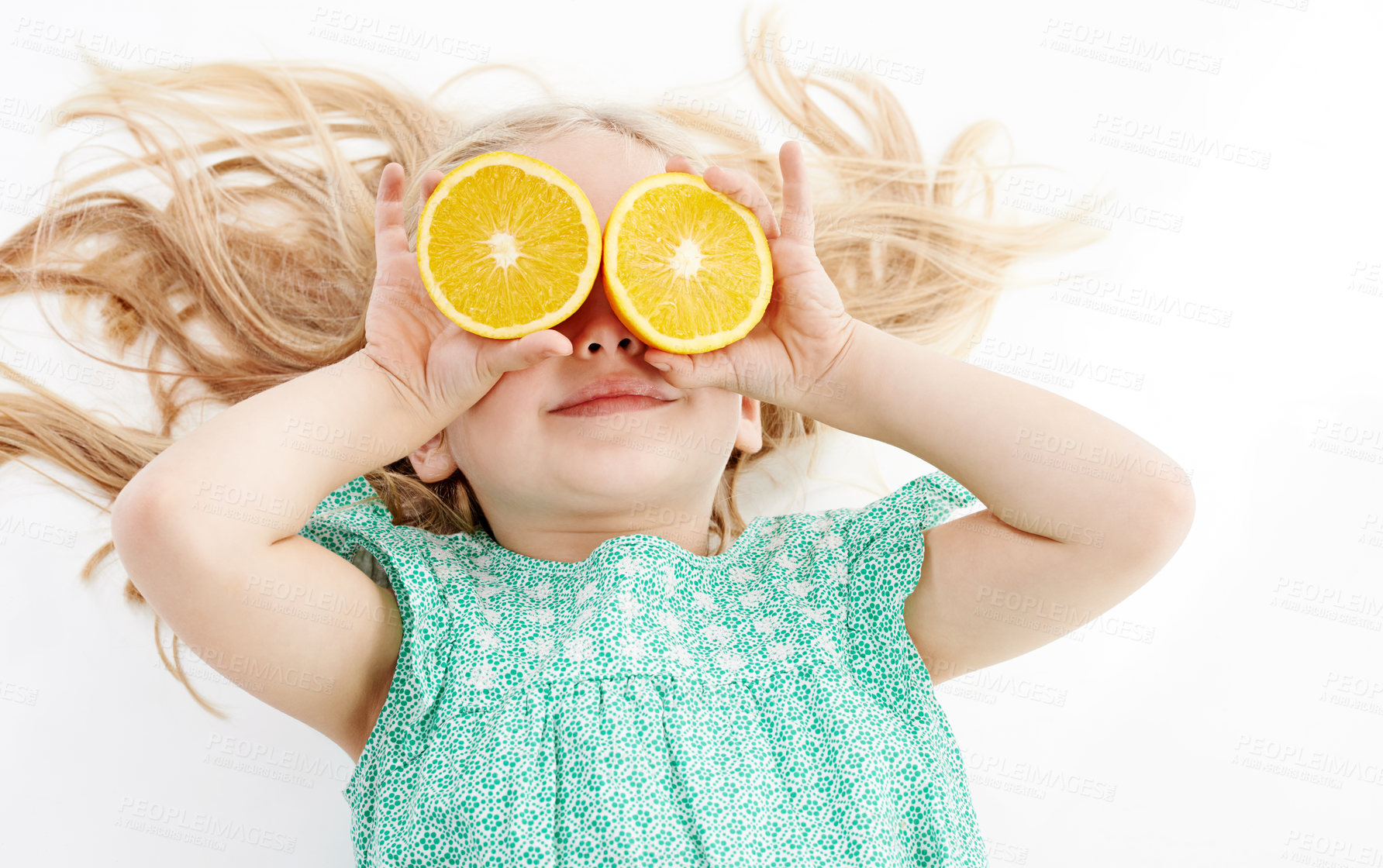 Buy stock photo Studio, hands and child with orange for health, nutrition and vitamin c for wellness with happiness. Relax, young girl and cover eyes with citrus fruit by white background for fiber, detox and diet