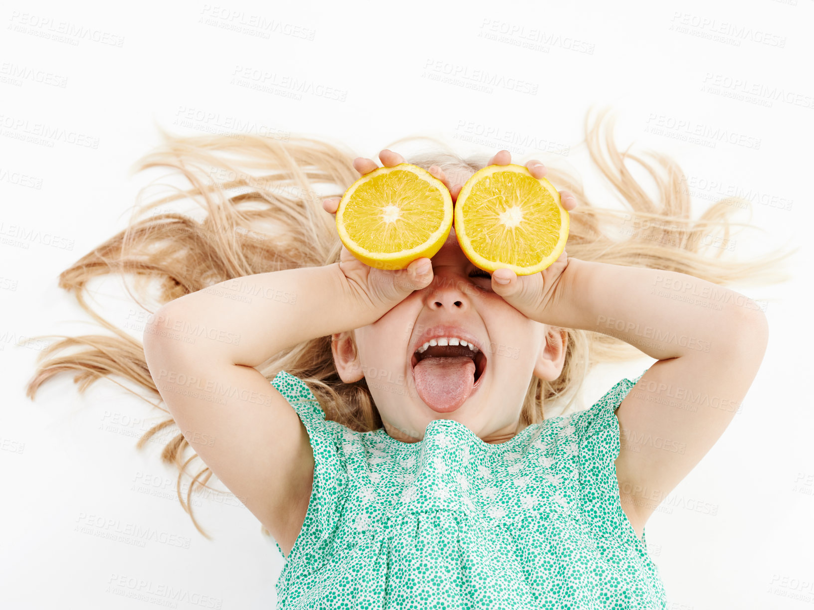 Buy stock photo Happy child, lemon or vitamin C with fruit for nutrition, detox or sour face on a white studio background. Young, kid or female person with smile or tongue out for citrus taste, diet or natural snack