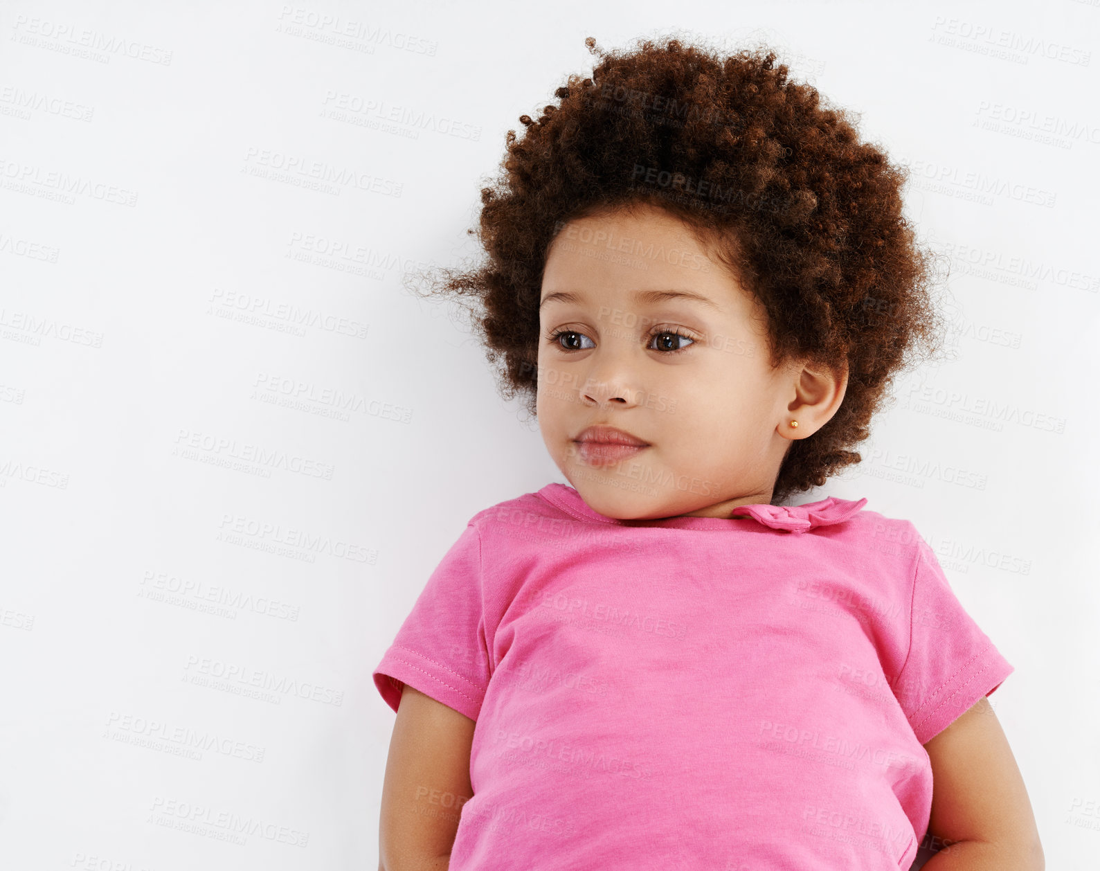 Buy stock photo Floor, happy and above of child in studio for relaxing, resting and chill on a white background. Smile, youth and isolated young girl laying with mockup space for development, growth and childhood