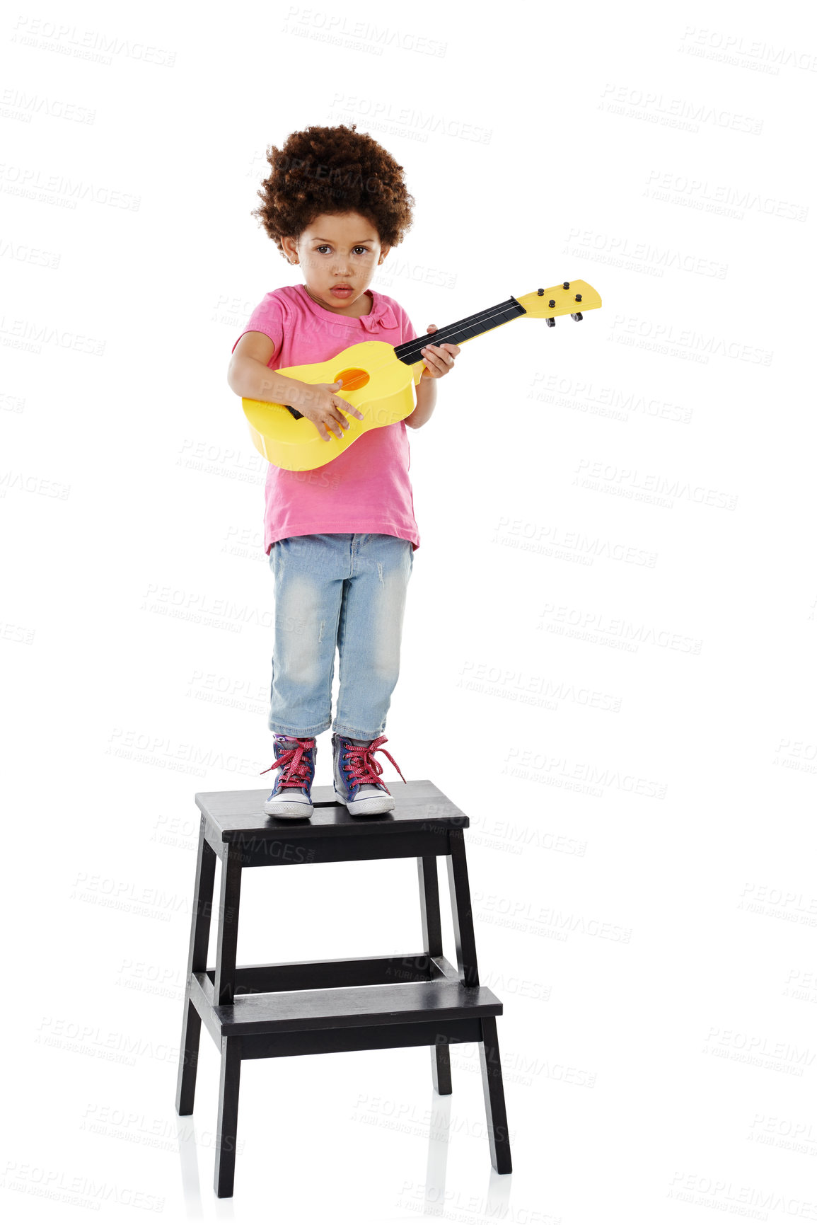 Buy stock photo Playing, guitar toy and child in studio on step for music, practice and learning songs. Childhood, creative and isolated young girl with musical instrument for pretend performance on white background