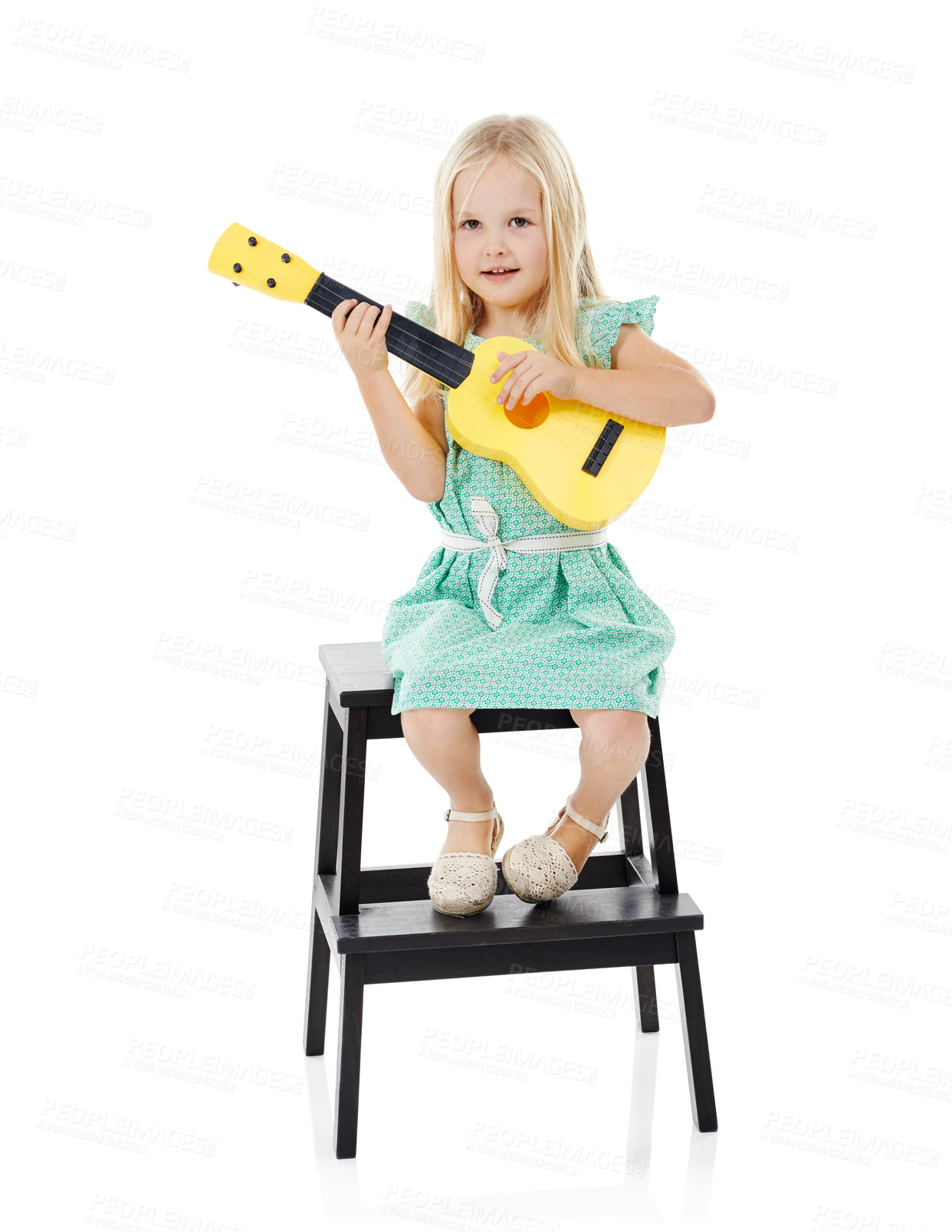 Buy stock photo Music, guitar and portrait of child in studio on step for playing on toy, practice and learning songs. Talent, creative and isolated young girl perform with musical instrument on white background