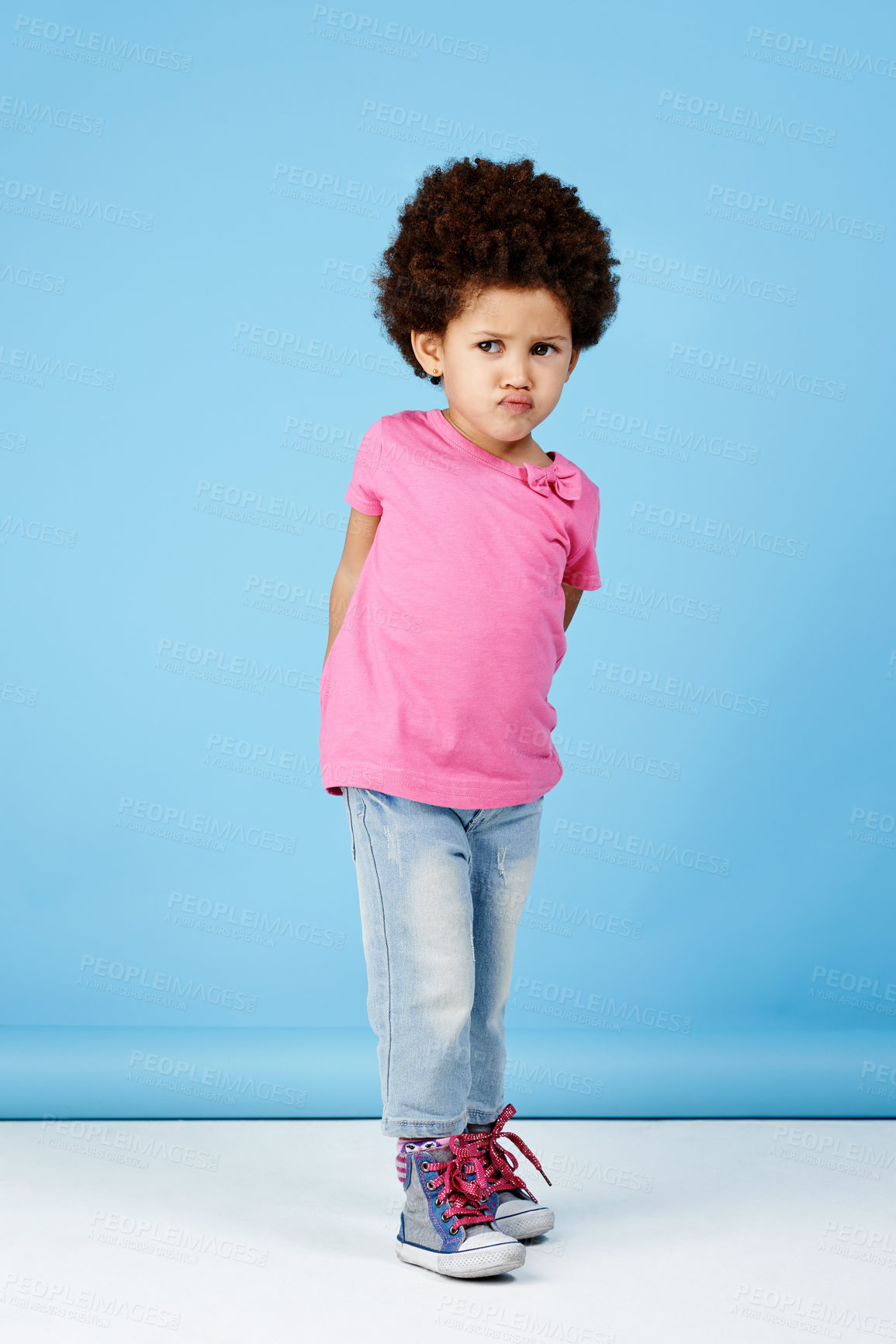 Buy stock photo Shot of an adorable little girl pouting while looking sad