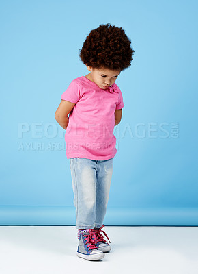 Buy stock photo Shot of an adorable little girl pouting while looking sad