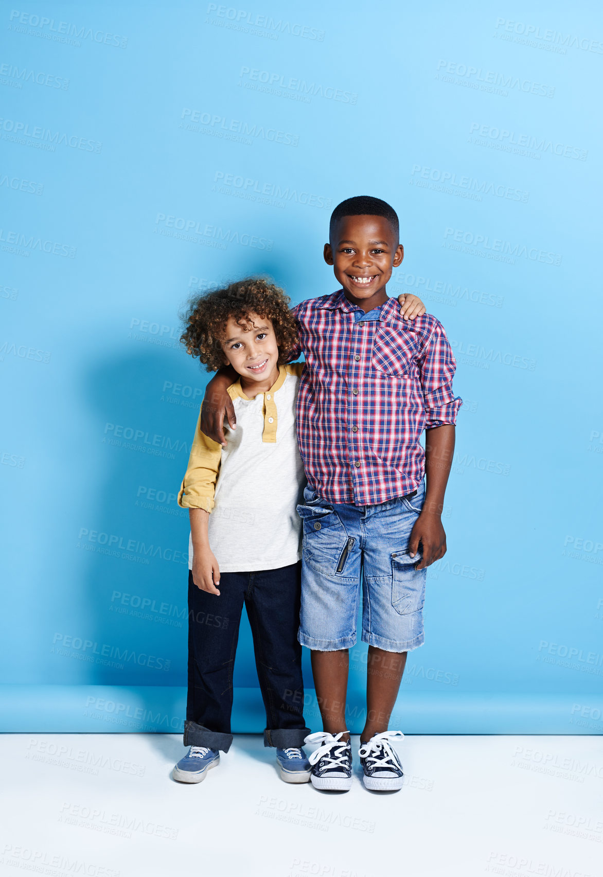 Buy stock photo Shot of two young boys smiling at the camera