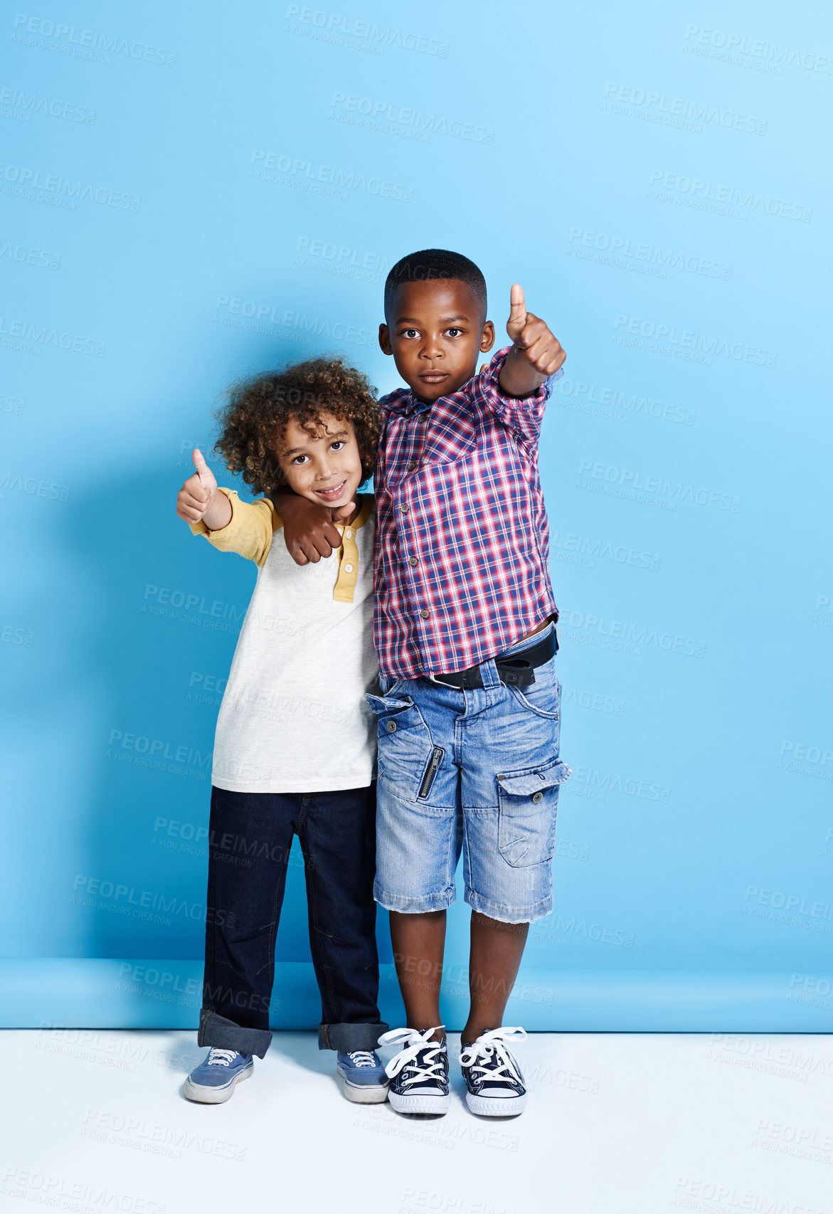 Buy stock photo Portrait, kids and friends with thumbs up in studio for success, support or cool fashion. African children, boys and like hand gesture for bonding, smile and embrace together on blue background space