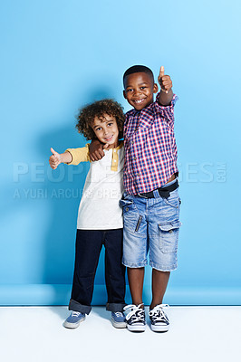 Buy stock photo Shot of two young boys showing thumbs up towards the camera