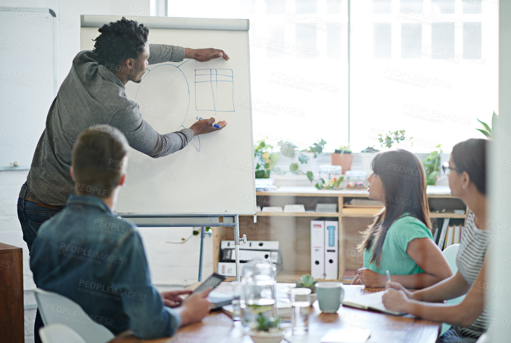 Buy stock photo Presentation, black man and brainstorming in office for meeting, business and leadership. Collaboration, team building and group with diversity in conference room for coaching or strategy for company