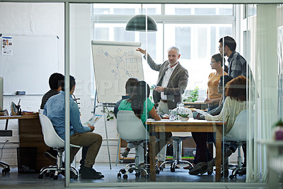 Buy stock photo Shot of a group of coworkers in a boardroom meeting