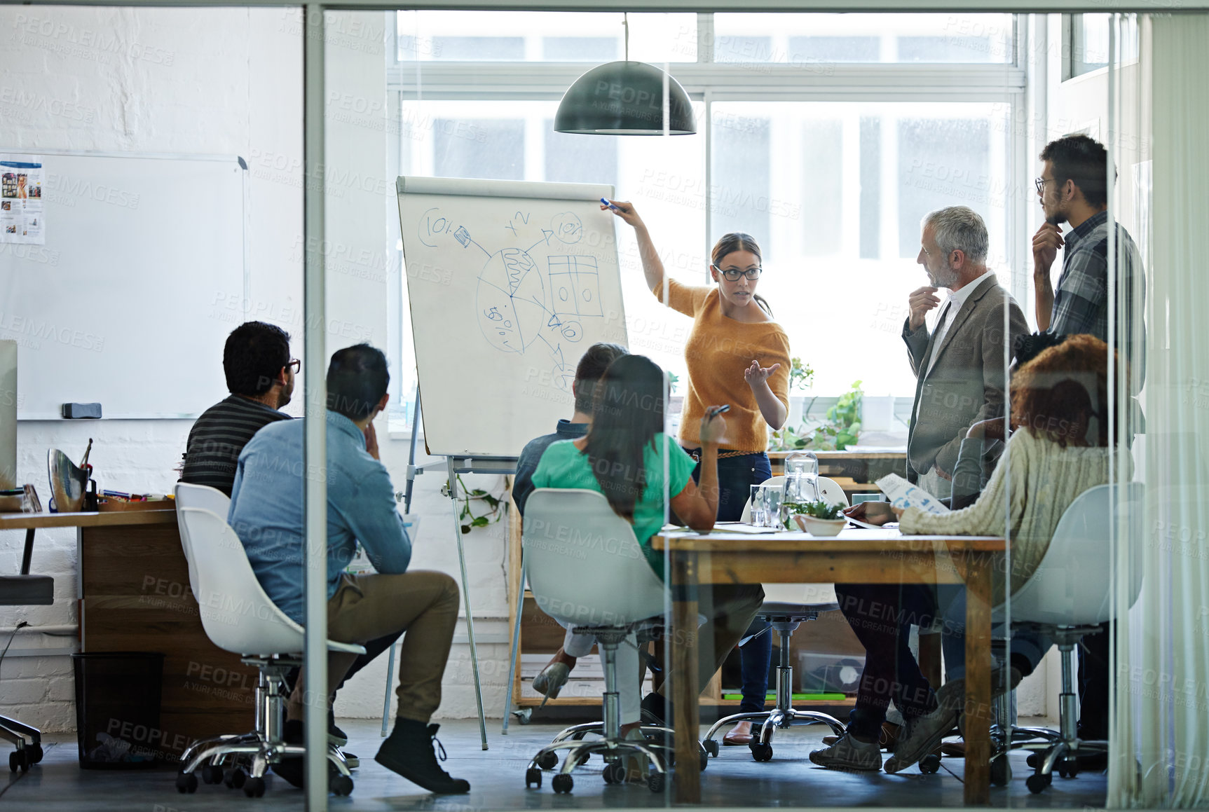 Buy stock photo Shot of a group of coworkers in a boardroom meeting