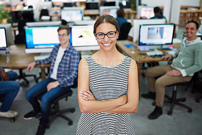 Buy stock photo Portrait of a young woman standing in an office with designers in the background