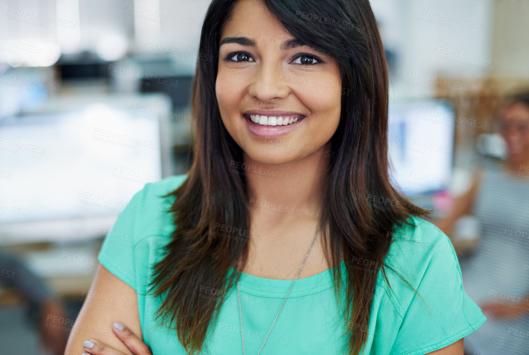 Buy stock photo Portrait of a young woman standing in an office with designers in the background