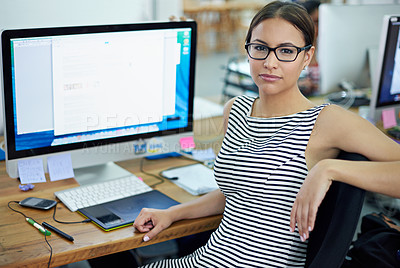 Buy stock photo Portrait of an attractive young woman sitting at her workstation in an office