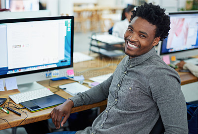 Buy stock photo Portrait of an handsome young man sitting at her workstation in an office