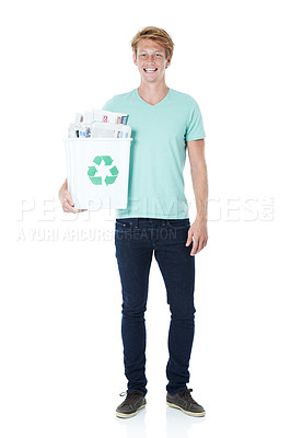 Buy stock photo A friendly young red-headed man holding a recycling bin filled with newspapers