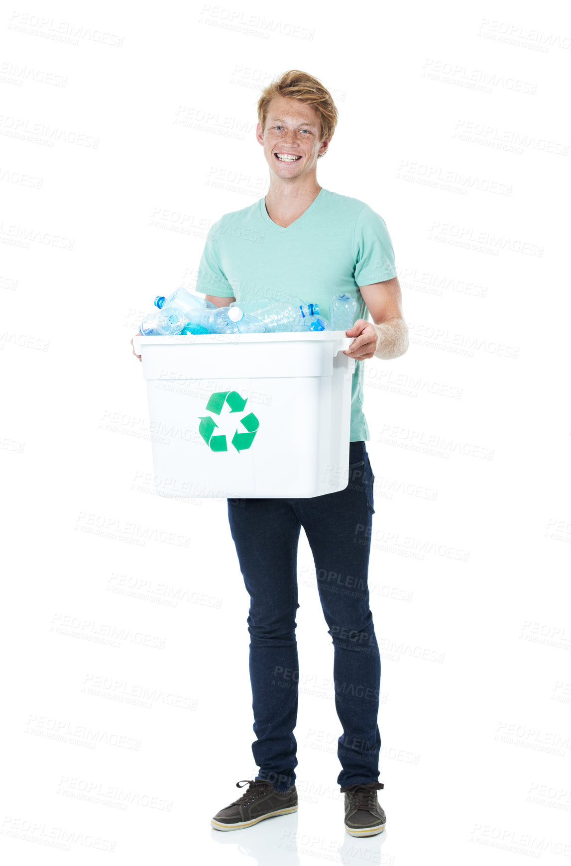 Buy stock photo A happy young red-headed man holding a recycling bin filled with empty plastic bottles