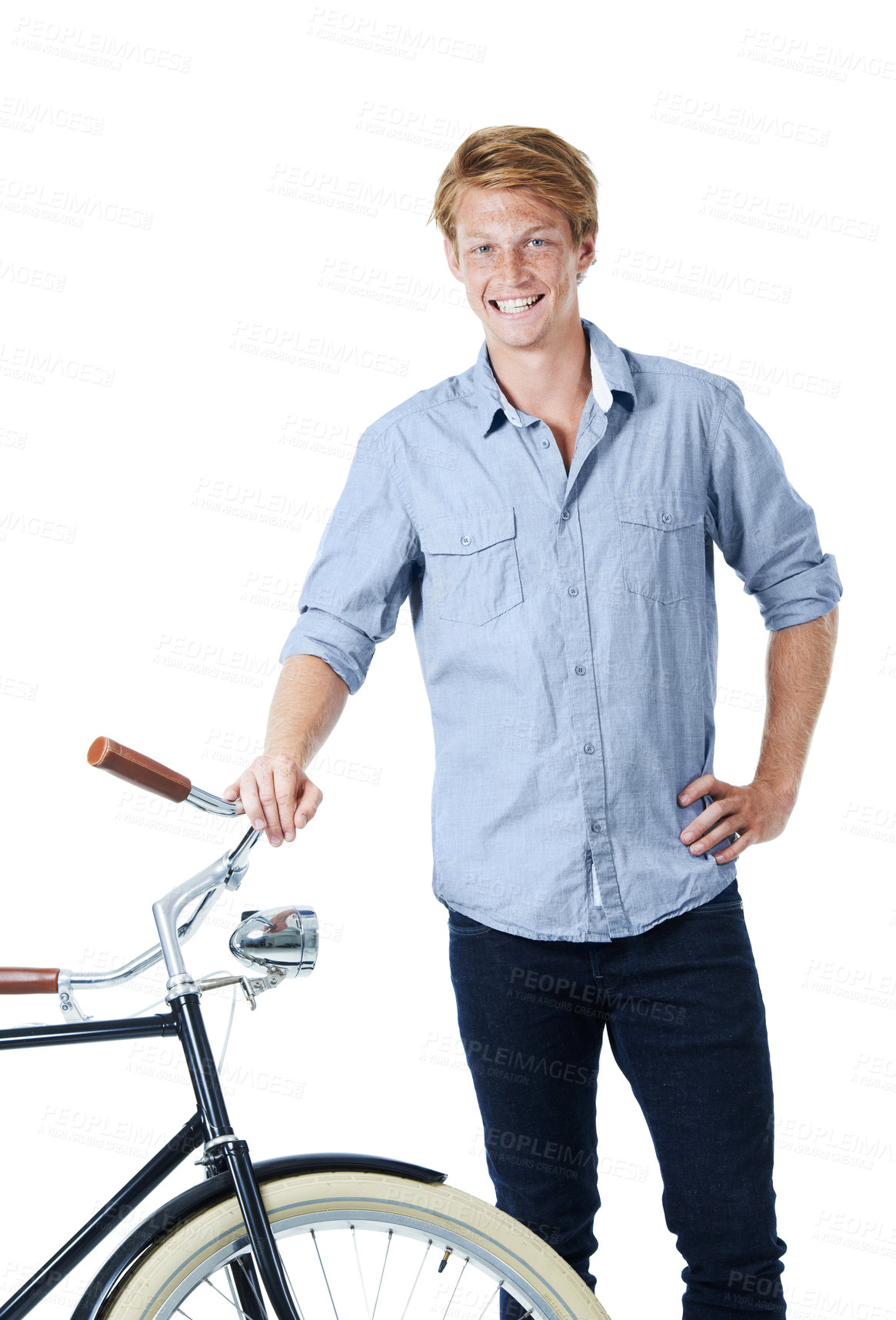 Buy stock photo A handsome young red-headed man standing next to an old-fashioned bicycle with his hand on his hip