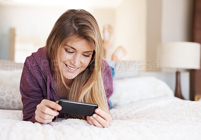 Buy stock photo Teenager, girl and smartphone, watching film and relax in bedroom, technology and streaming service. Young female person at home, movie subscription and mobile app with happiness, gen z and internet