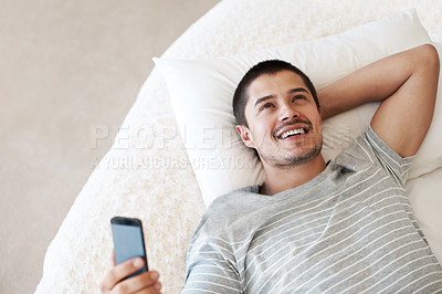 Buy stock photo Man, happy and thinking with a phone on a bed for communication, chat or notification at home. Happy young person with a smartphone for message idea with internet connection, app and social media