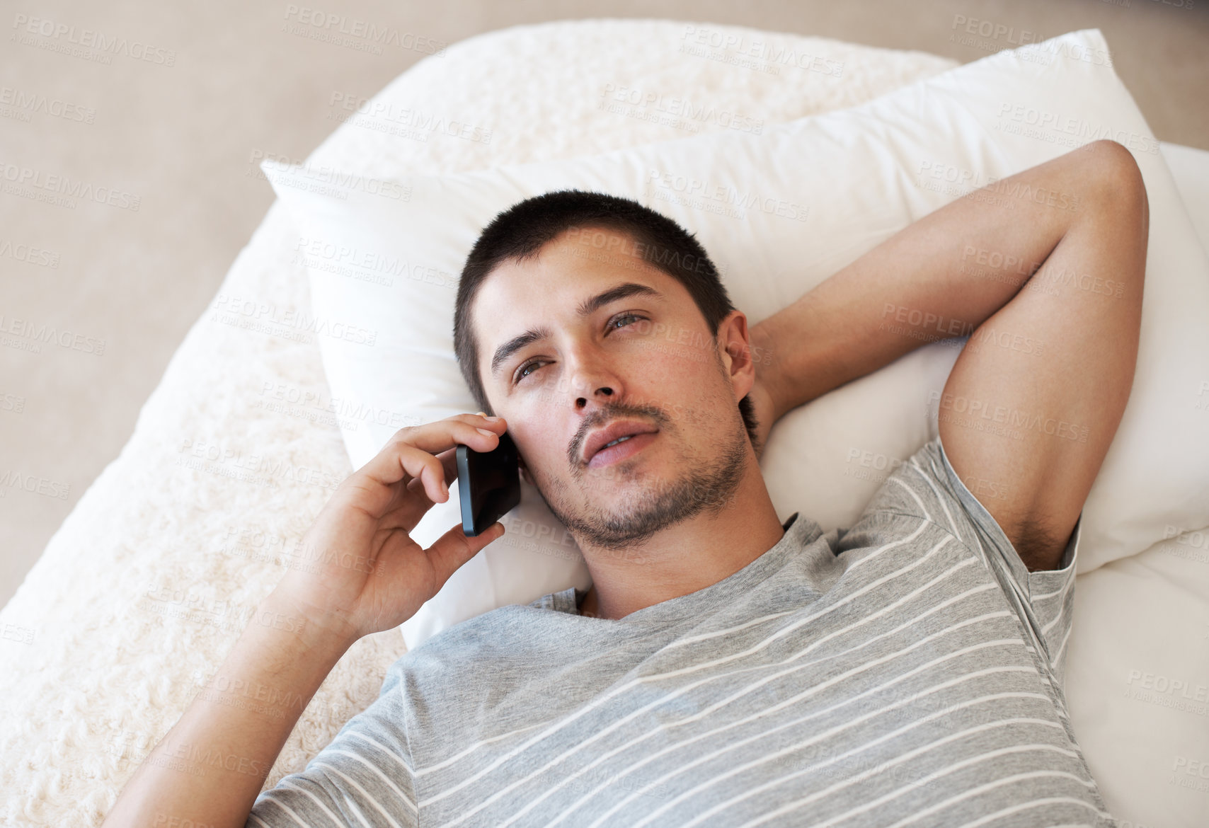 Buy stock photo Man, phone call and talking on bed in home for conversation, mobile chat and communication on top view. Serious person, smartphone and relax in bedroom with thinking, discussion or social network