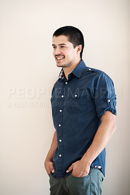 Buy stock photo Handsome young man with his hands in his pockets and a broad smile