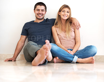 Buy stock photo Happy young couple sitting together and smiling 