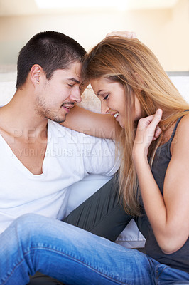 Buy stock photo A happy young couple relaxing together at home