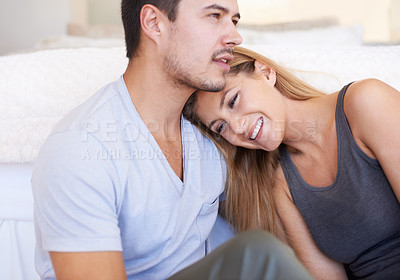 Buy stock photo A happy young couple relaxing together at home