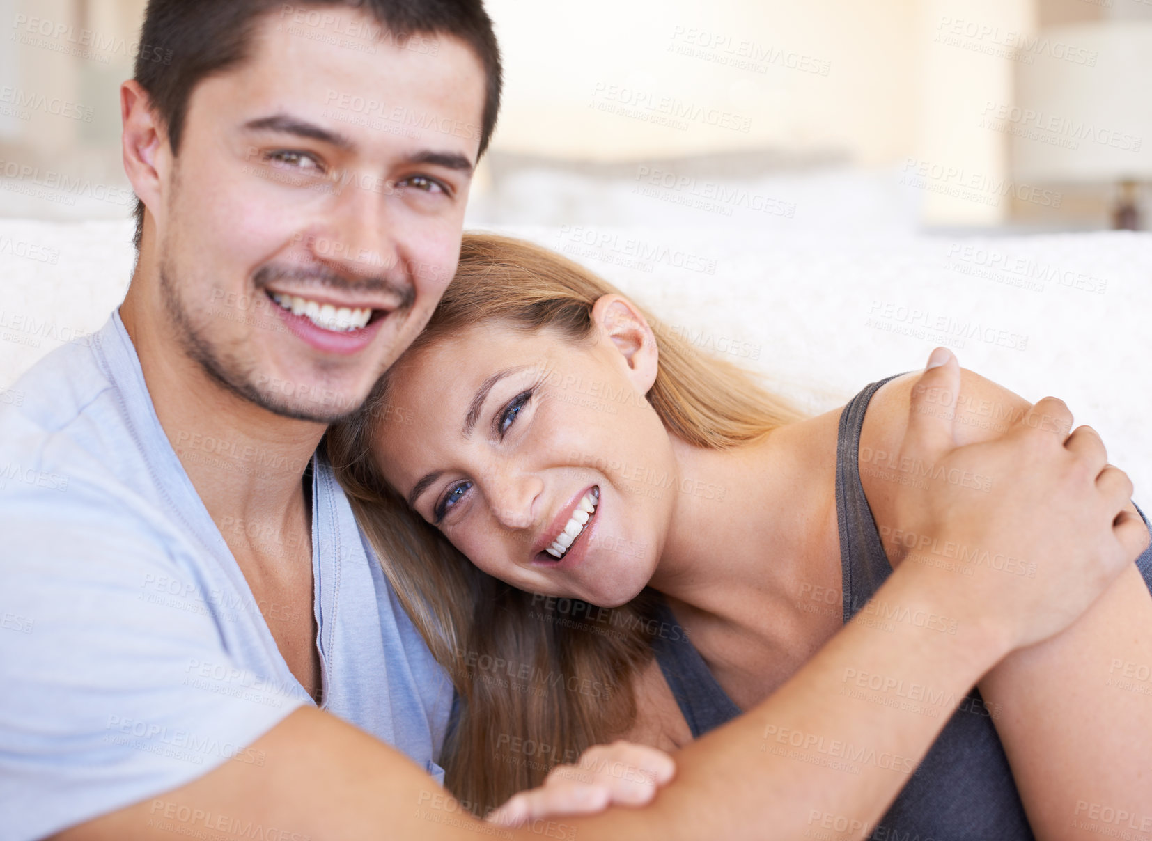 Buy stock photo Happy, hugging and portrait of couple in home with love, marriage and romantic connection in living room. Smile, cute and people embracing, relaxing and bonding in relationship together in house.
