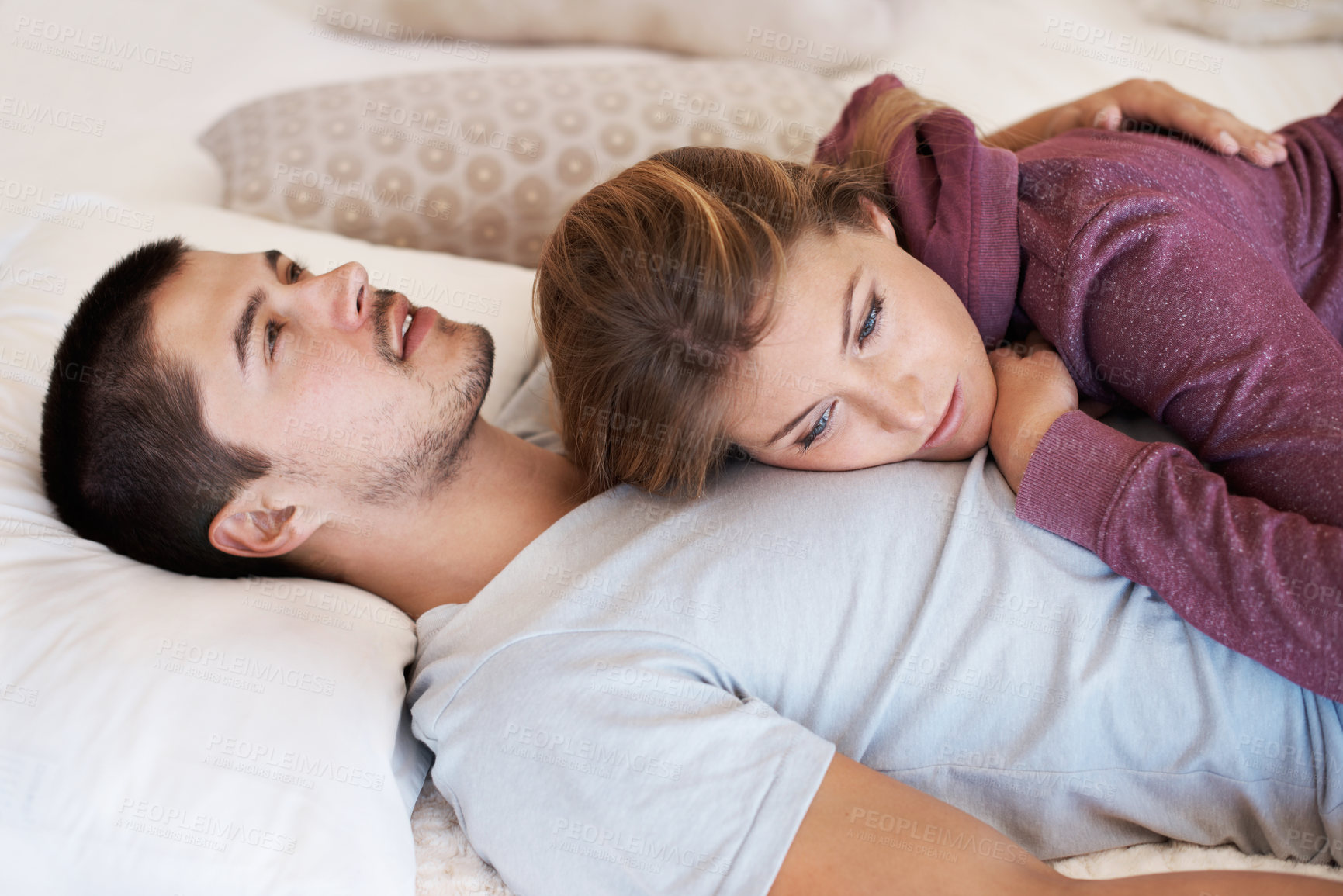 Buy stock photo Attractive young couple lying together at home