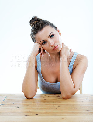 Buy stock photo Beautiful young woman sitting and looking bored