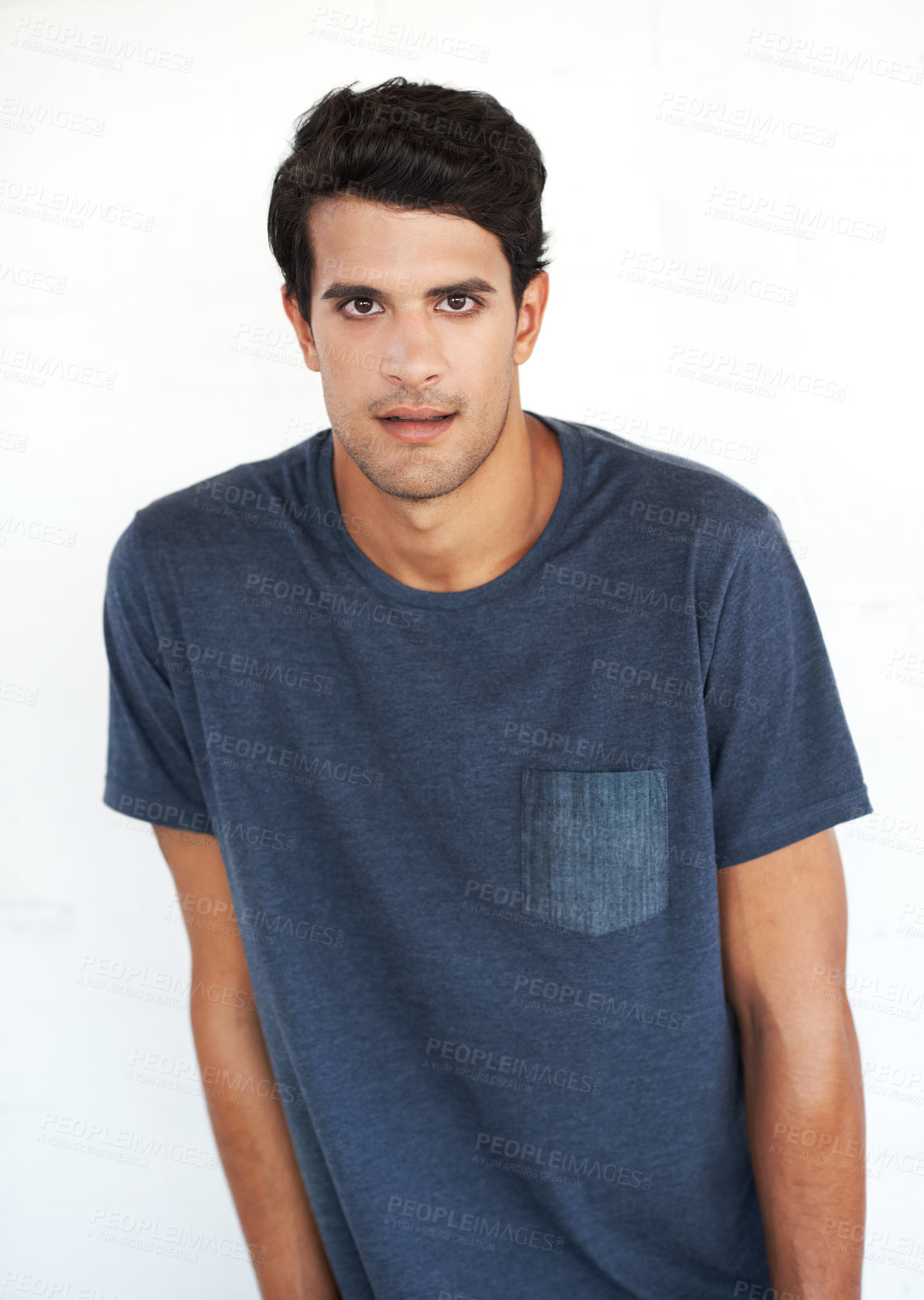 Buy stock photo Portrait, man and fashion in studio with confidence in casual wear, style and outfit on white background in Spain. Male person, isolated and serious with street look, swag and comfortable on T-shirt